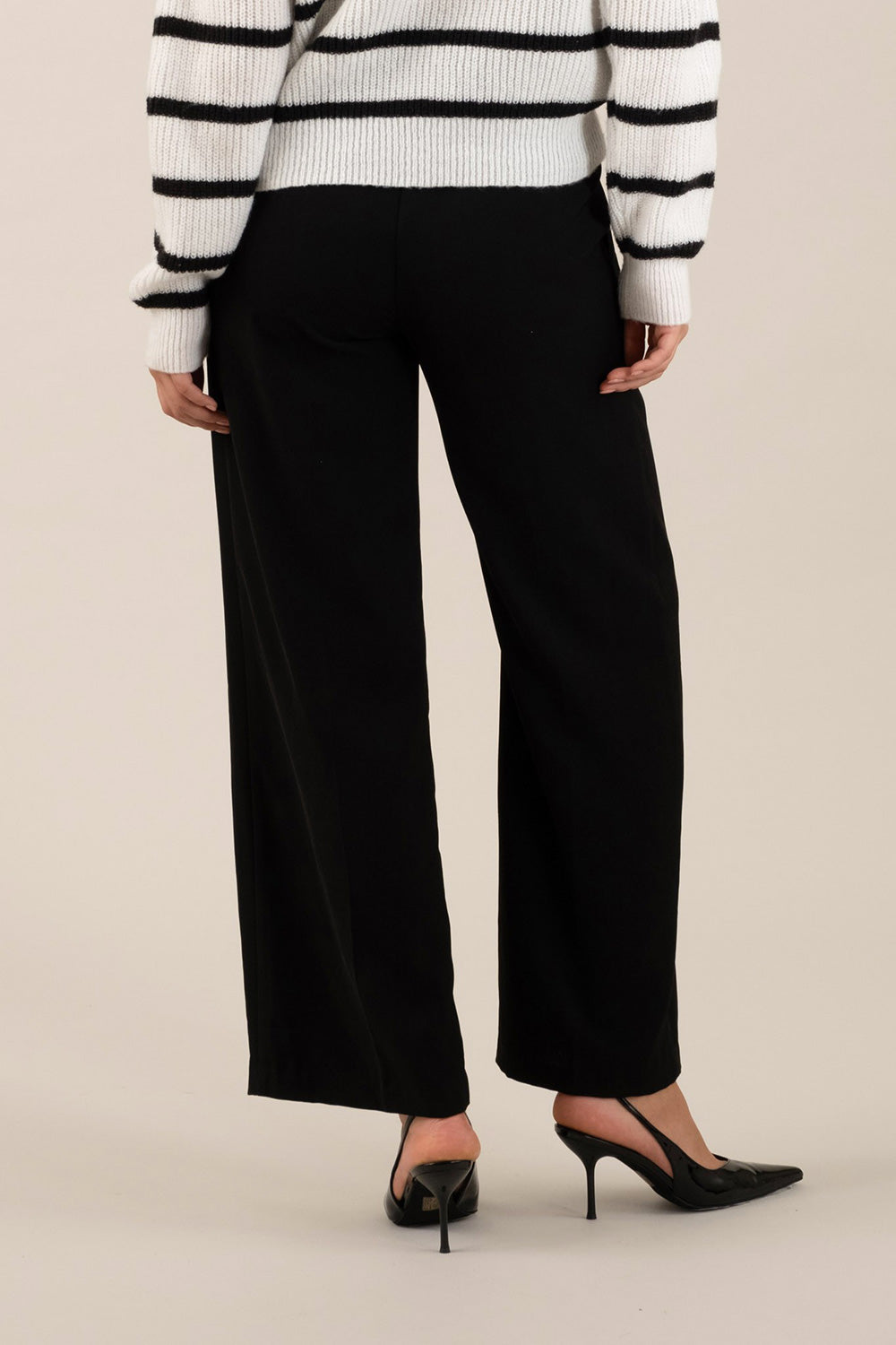 back view of a woman wearing Cortona Black Straight-Leg Pants with Pleats from La petite garçonne 