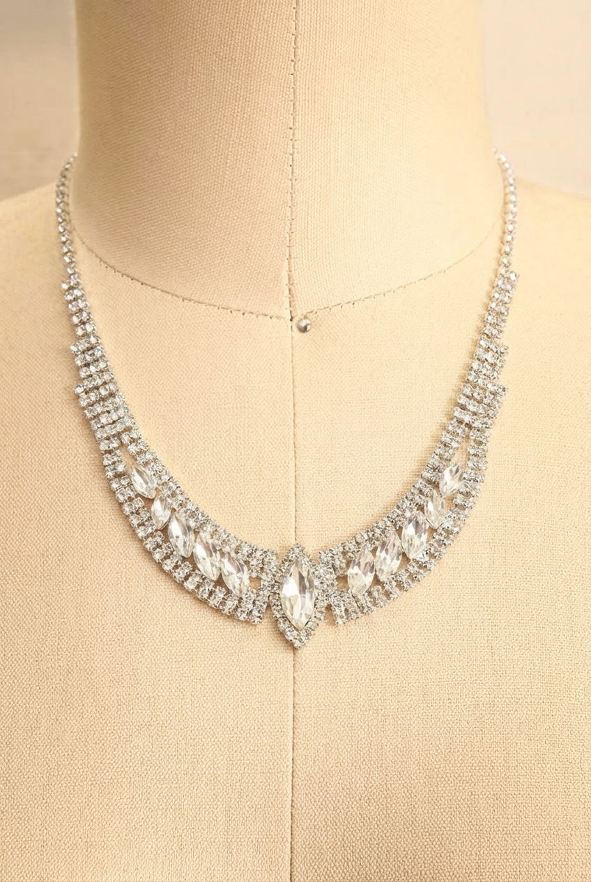 Close up of a sparkling 2-piece marquise-cut crystal linked earring and necklace set named Costanza from boutique 1861