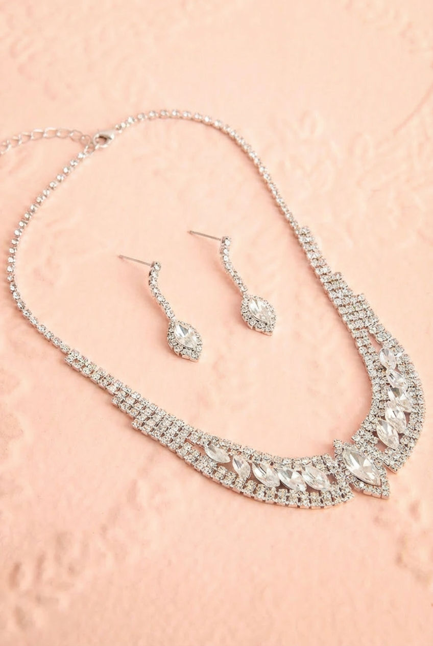 Top shot of a sparkling 2-piece marquise-cut crystal linked earring and necklace set named Costanza from boutique 1861