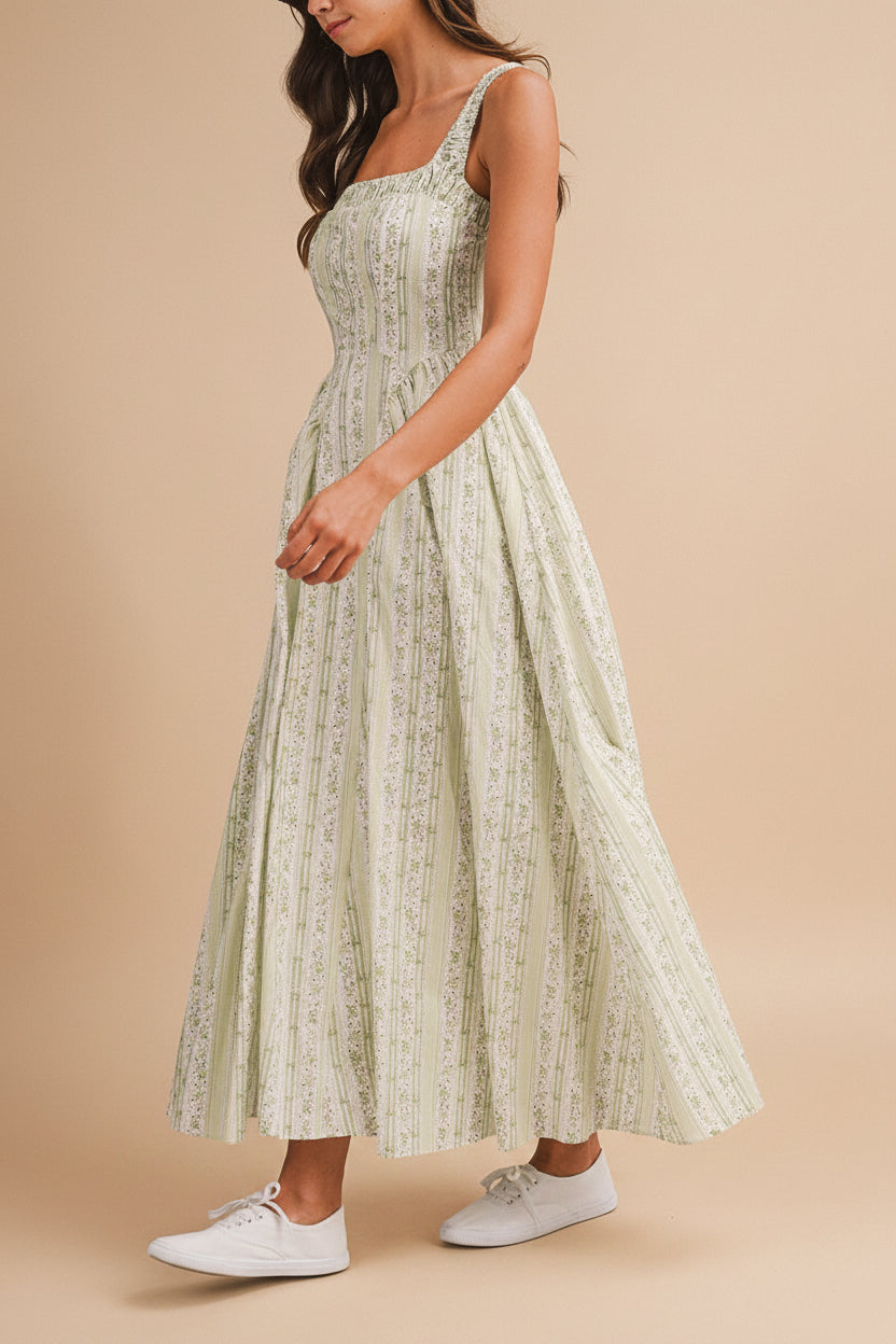 side view of a woman wearing Daiko Green Floral A-Line Maxi Dress with Corset Bust from Boutique 1861