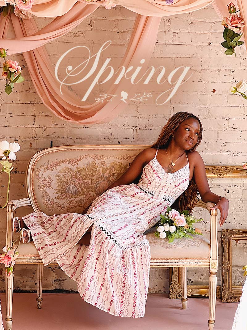 Banner featuring a woman lying on a sofa wearing a floral dress from boutique 1861 Spring Collection