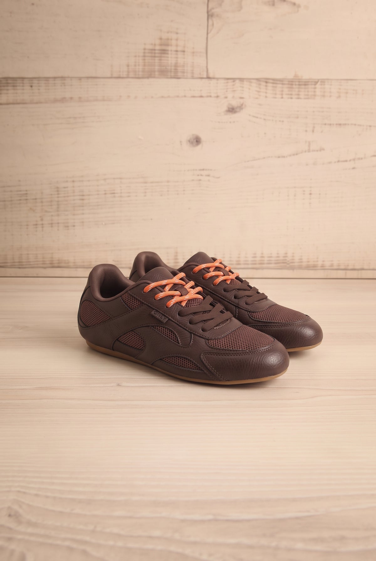 Side view of a pair of Edelweiss Brown Lace-Up Sneakers from Only at la petite garçonne wood background in Montreal