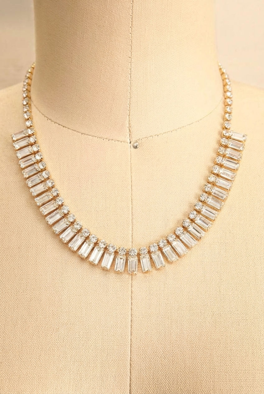 Close-up of a gold sparkling necklace and earrings Emirina with Square Cut Crystal Linked from boutique 1861