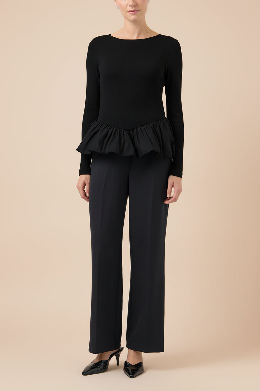 fornt view of a woman wearing Henrieta Black Fitted Top with Peplum from Boutique 1861 