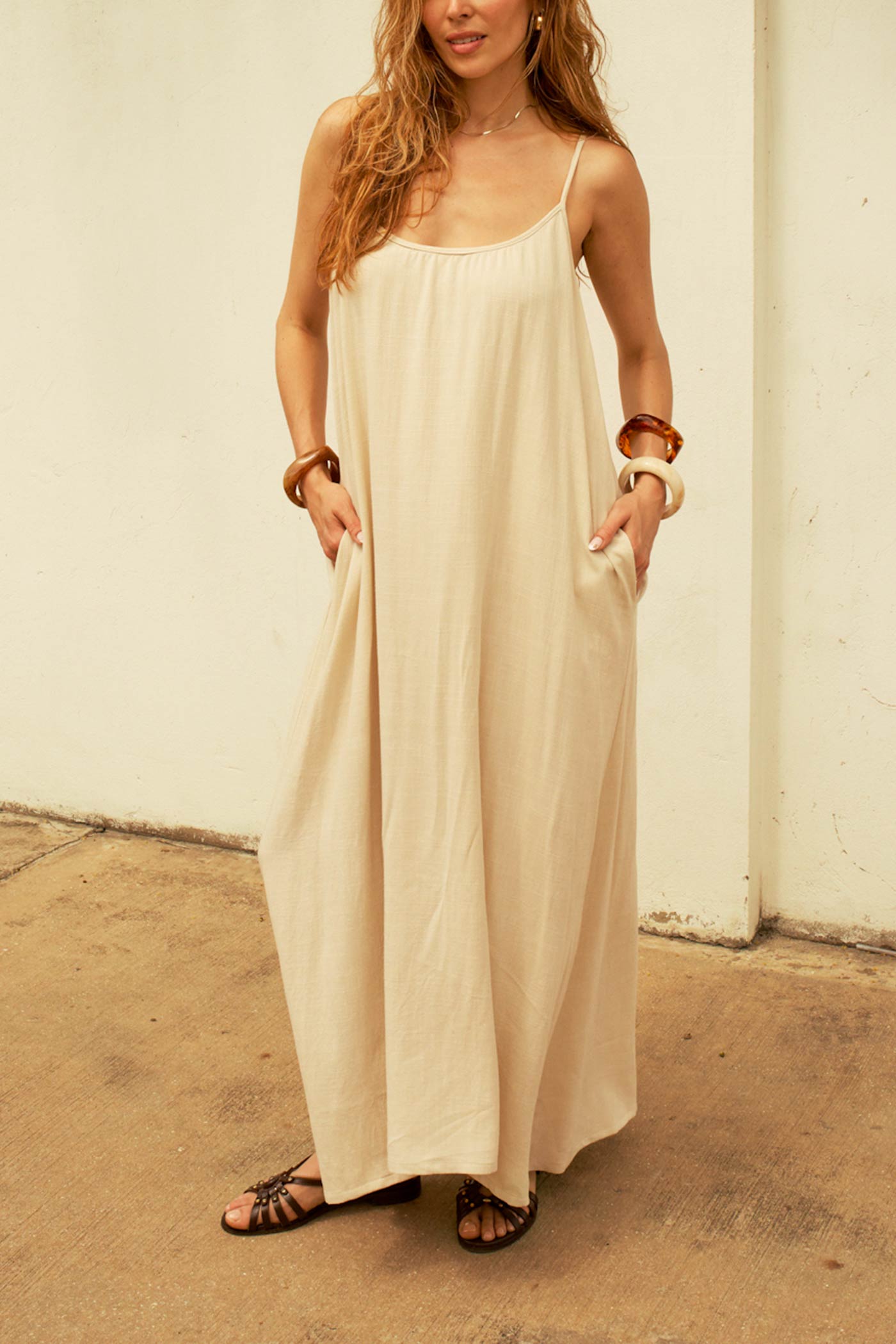 Woman wearing Isabela Dress Beige  Flowy Maxi Dress with Pockets and Ajustable Straps by Dailystory