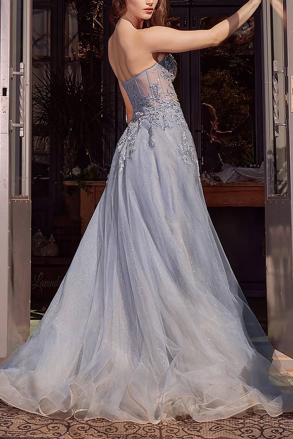 side of a woman wearing Jayden Maxi Blue Dress with Floral Beading from Boutique 1861