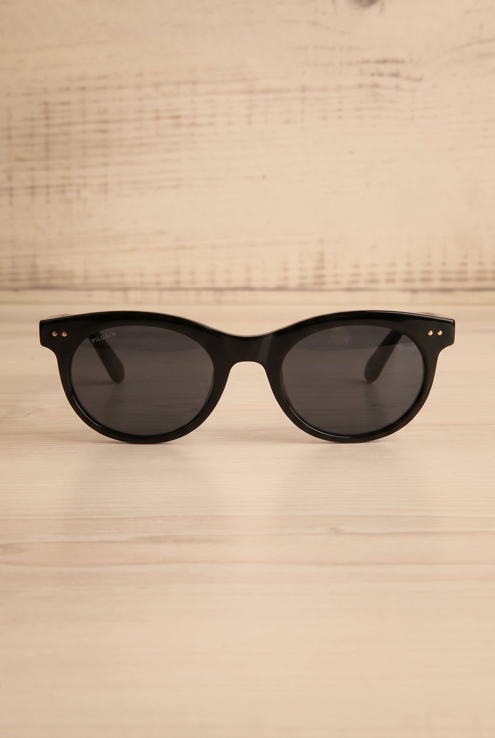 Frontview studio view of Jelena Black Circular Sunglasses by Pilgrim at la petite garçonne
