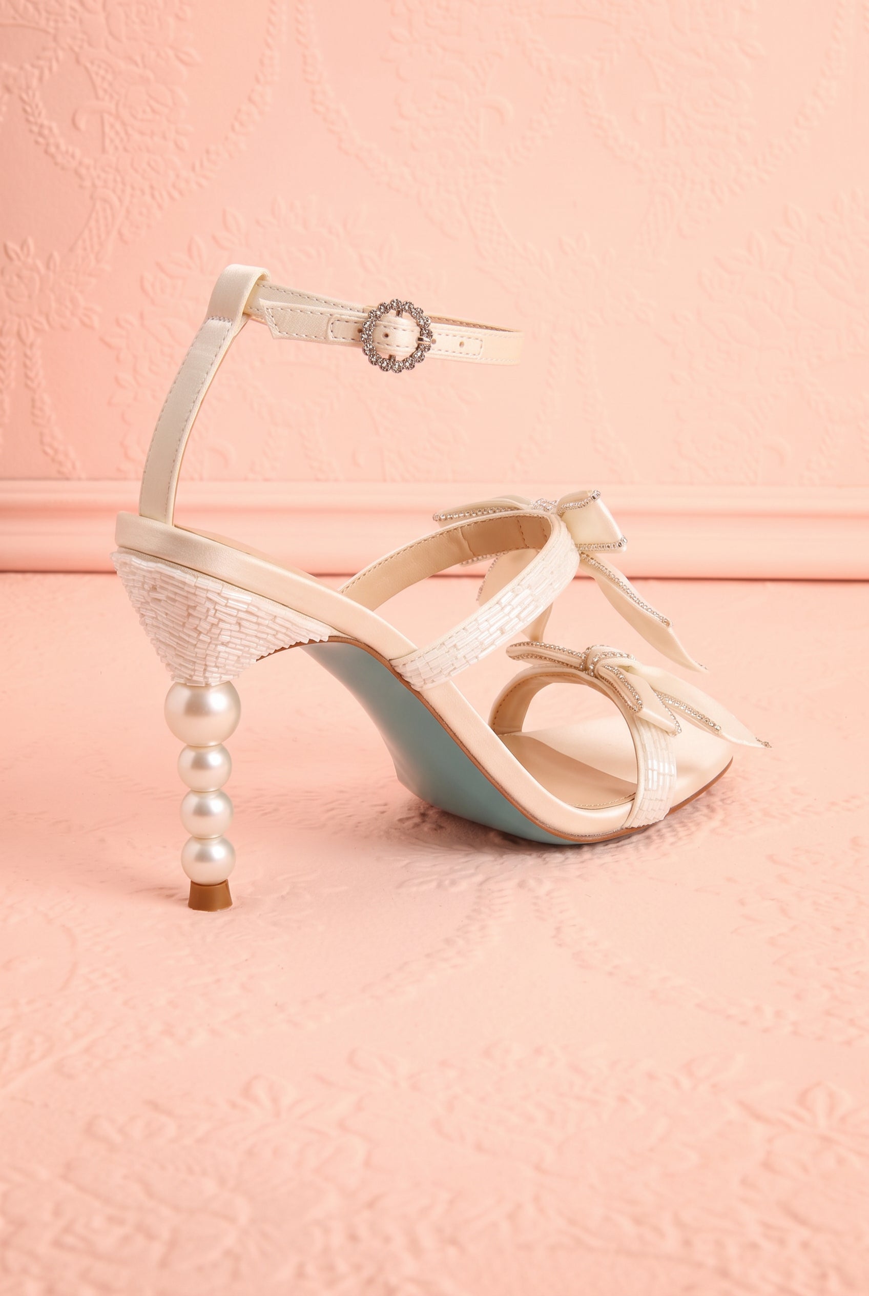Back view of Jerusa Ivory Sparkling High-Heel Sandals with Bows at boutique 1861