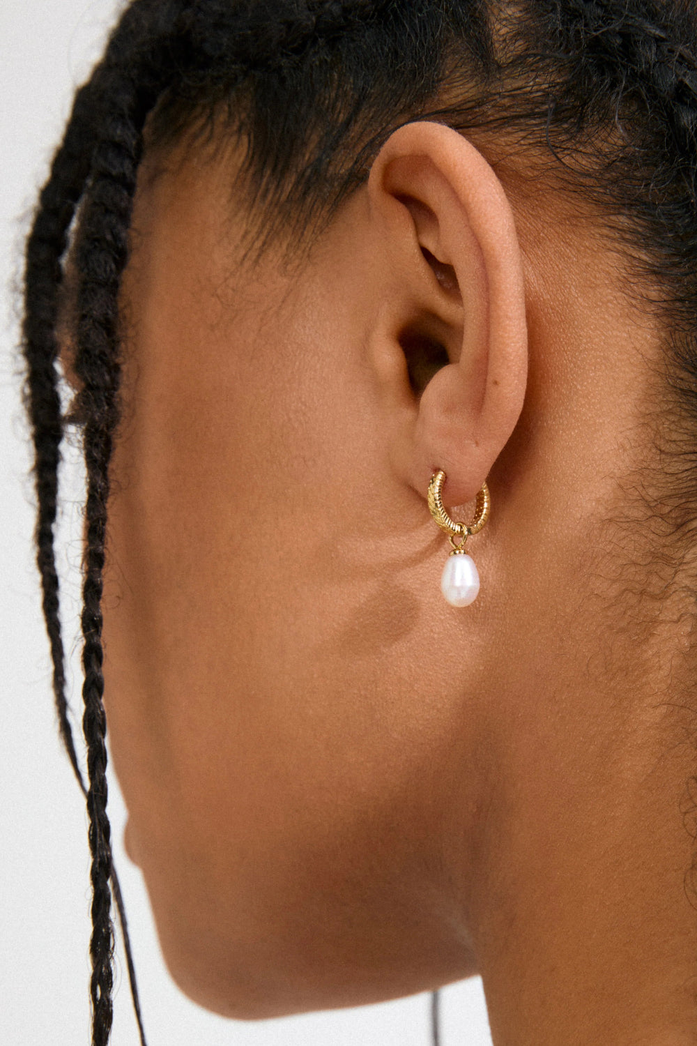 Woman with braided hair wearing a Gold hoop earrings  Labasa by Pilgrim available at la petite garçonne