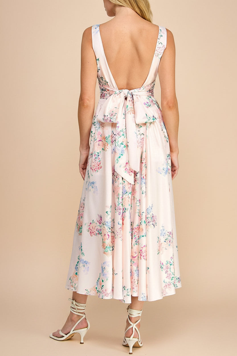 back view of a woman wearing Leah A-Line Midi Pink Floral Dress with Ribbons at Back from Boutique 1861