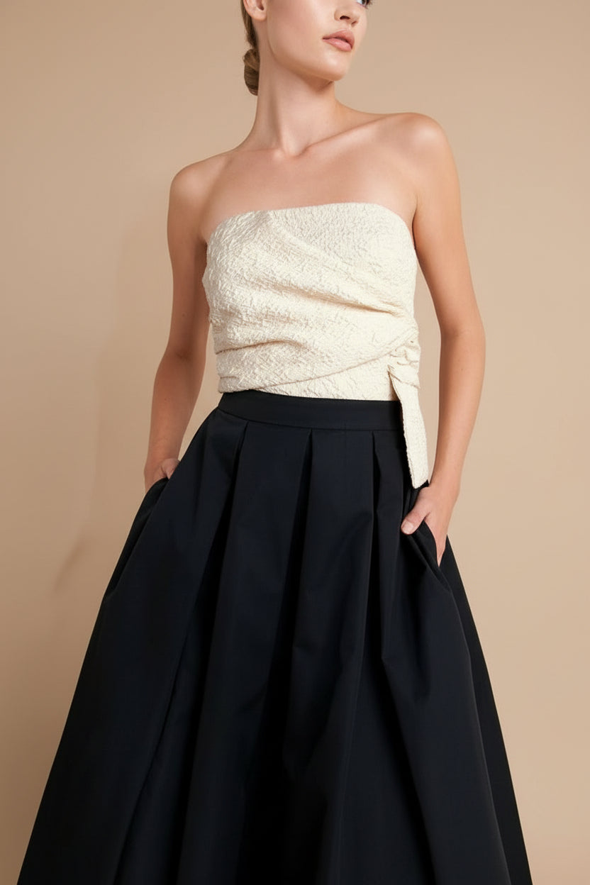 front of a woman wearing Lindsay Midi Strapless Dress with Draped Bodice from Boutique 1861
