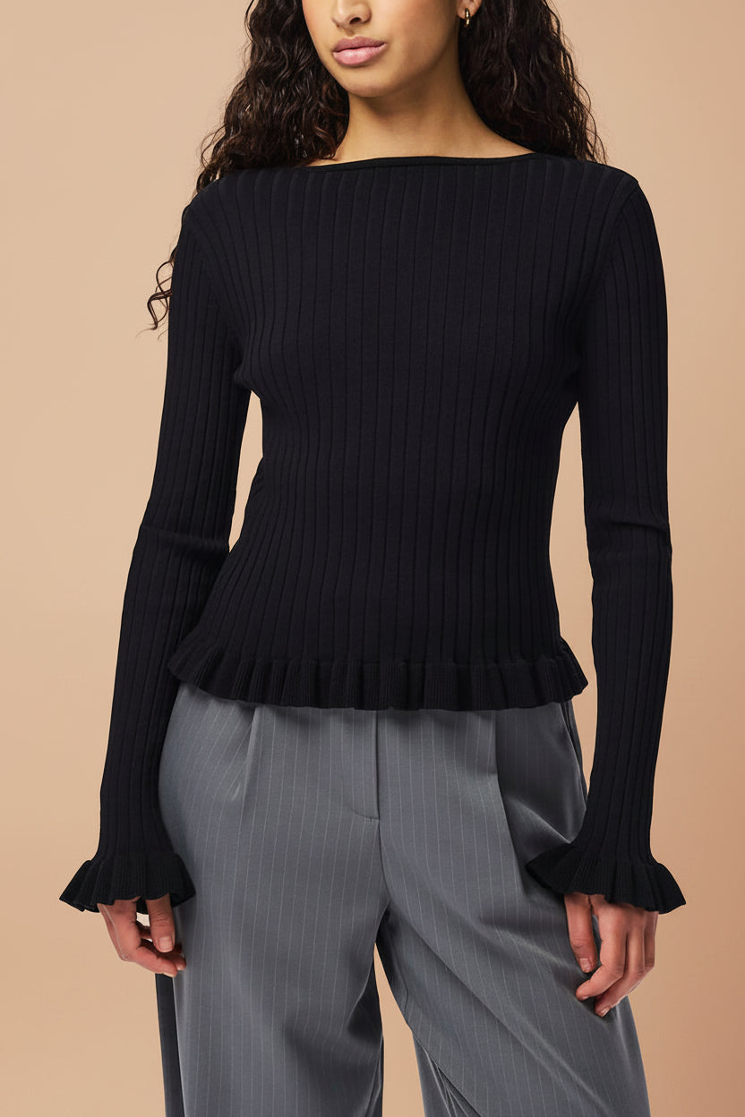 close front of a woman wearing Lortona Black Ribbed Knit Cardigan with Front Tie and Frill Details from La petite garçonne