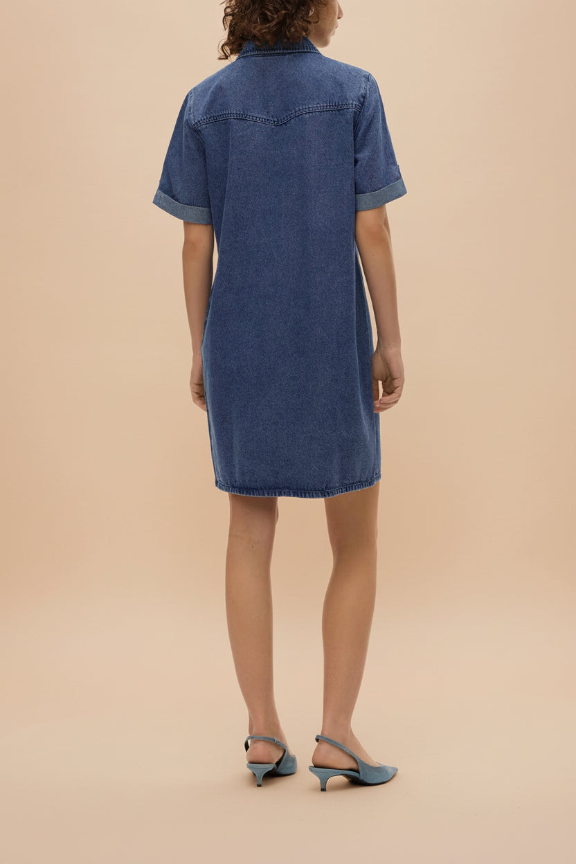 back of a woman wearing Malda Short Blue Denim Shirt Dress with Pockets from La petite garçonne 