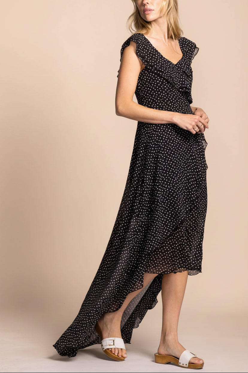 side view of a woman wearing Maralda Black Maxi Dress with Polka Dots from Boutique 1861