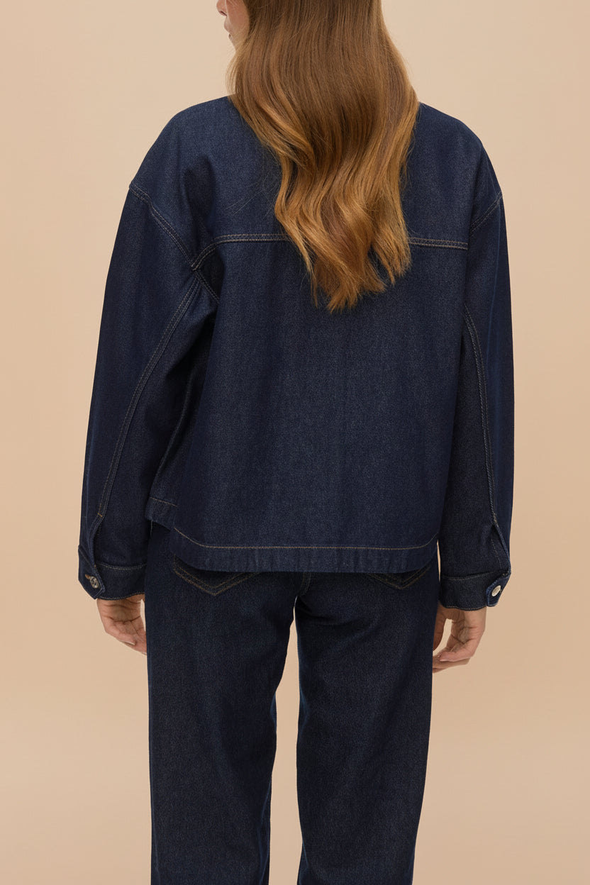 back of a woman wearing Matera Dark Wash Denim Button-Up Jacket with Pockets from La petite garçonne