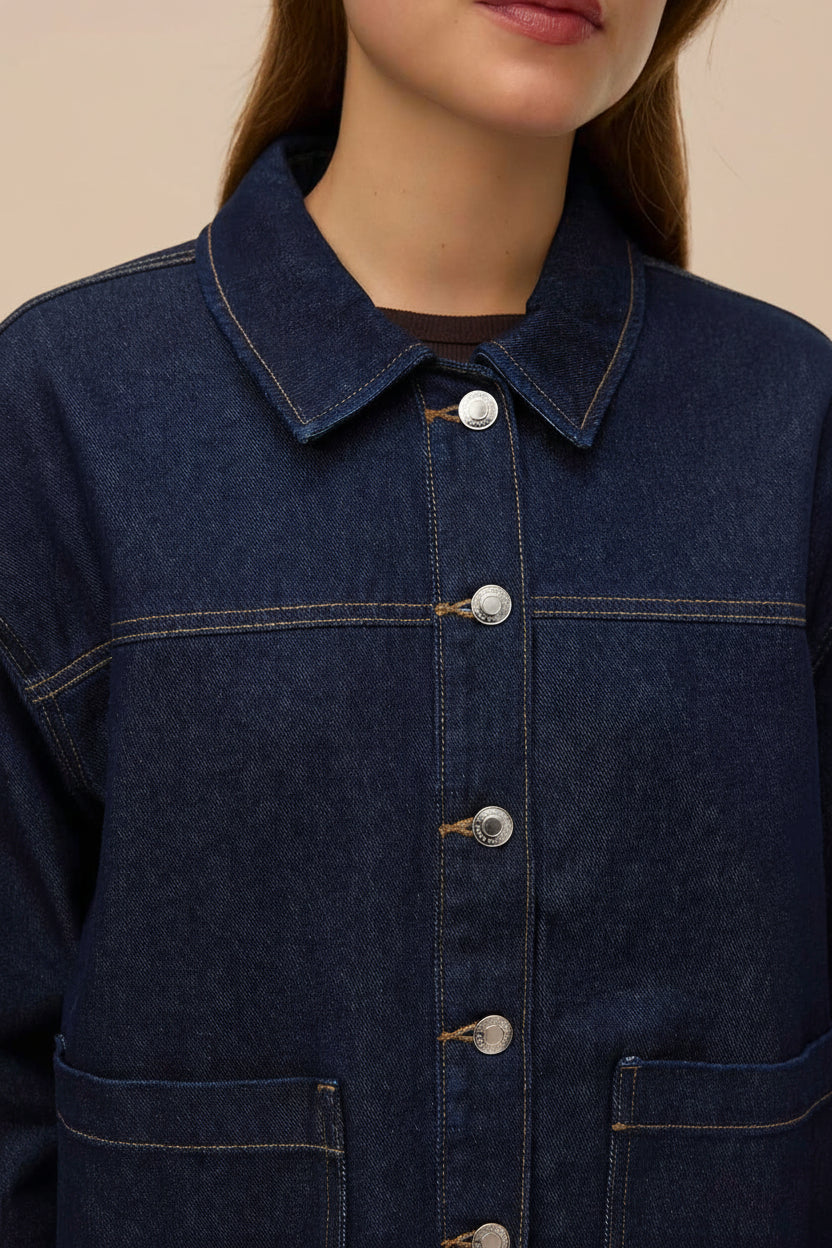 close-up of a woman wearing Matera Dark Wash Denim Button-Up Jacket with Pockets from La petite garçonne