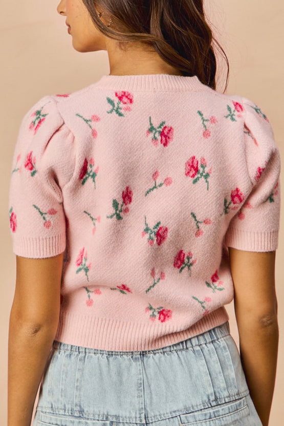 back view of a woman wearing Mavis Pink Knit Top with Floral Pattern from Boutique 1861