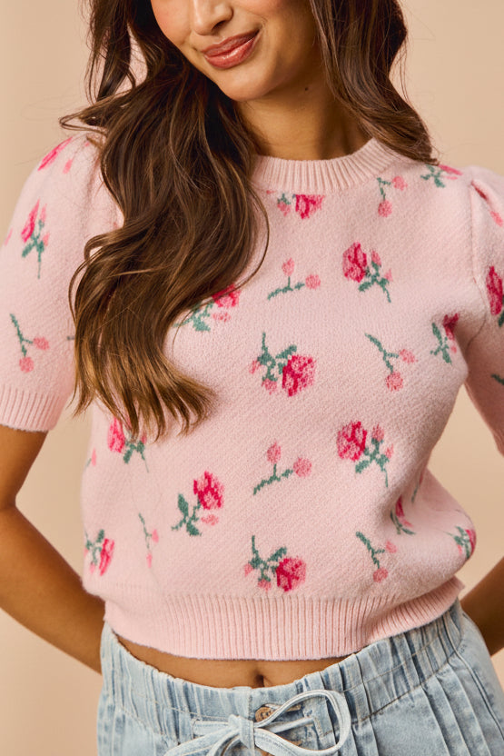 front view of a woman wearing Mavis Pink Knit Top with Floral Pattern from Boutique 1861