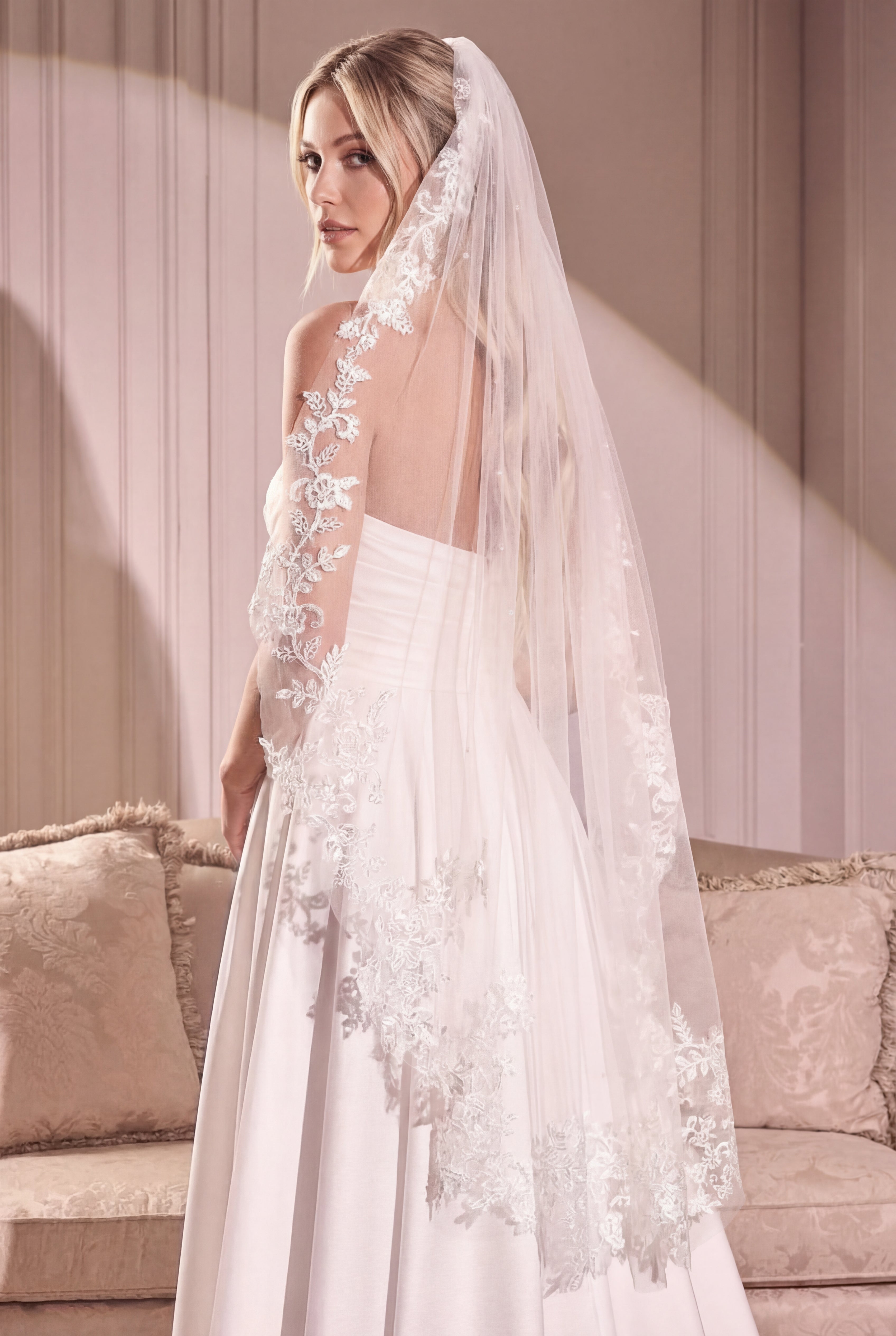 Woman wearing the Mirelisse Ivory Tulle Wedding Veil with Floral Appliqués from Boudoir 1861 