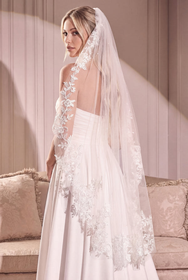 Woman wearing the Mirelisse Ivory Tulle Wedding Veil with Floral Appliqués from Boudoir 1861 