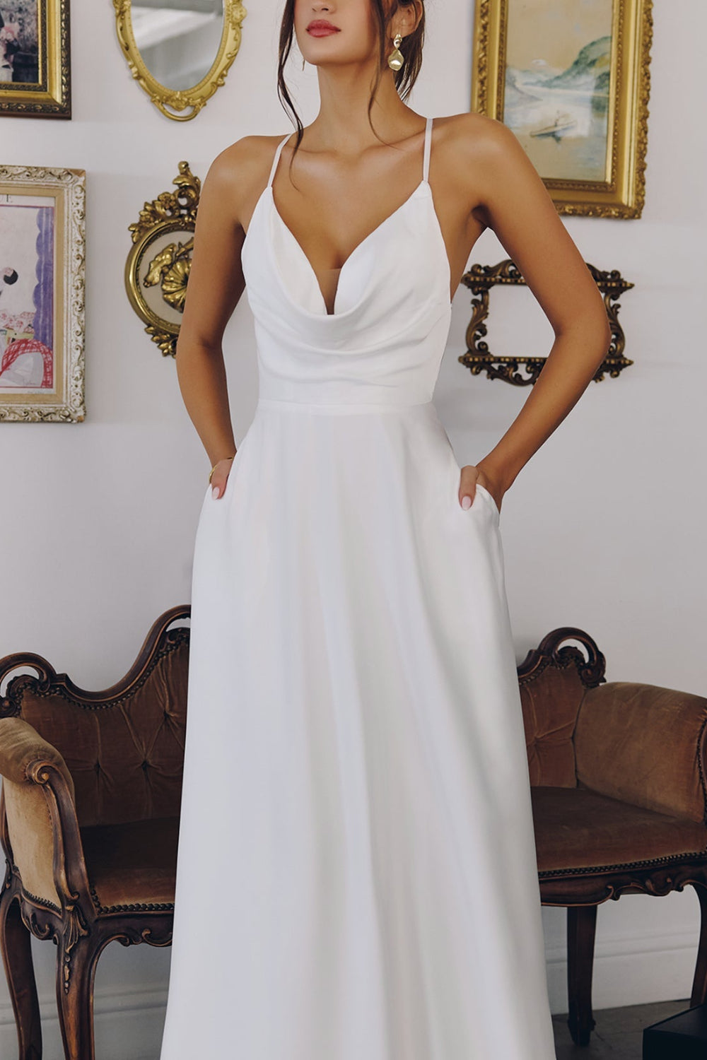 Woman in a white dress Nadiene from Boudoir 1861 standing in an elegant room with decorative elements. 