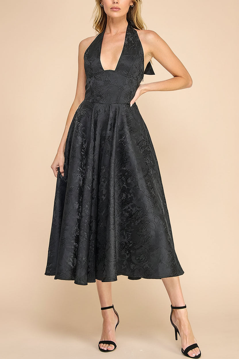 front of a woman wearing Nedjima Black Midi Jacquard Dress with Halter Neck from Boutique 1861