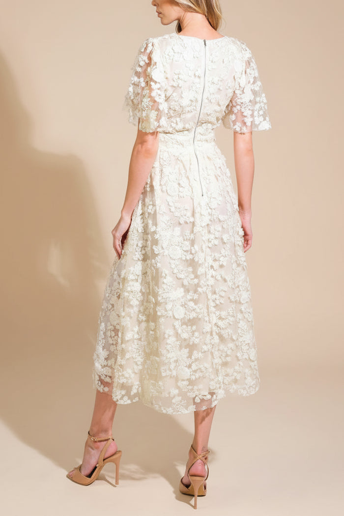 Back view of a Woman wearing Oukie Ivory, a Midi Floral Lace Dress from Boudoir 1861