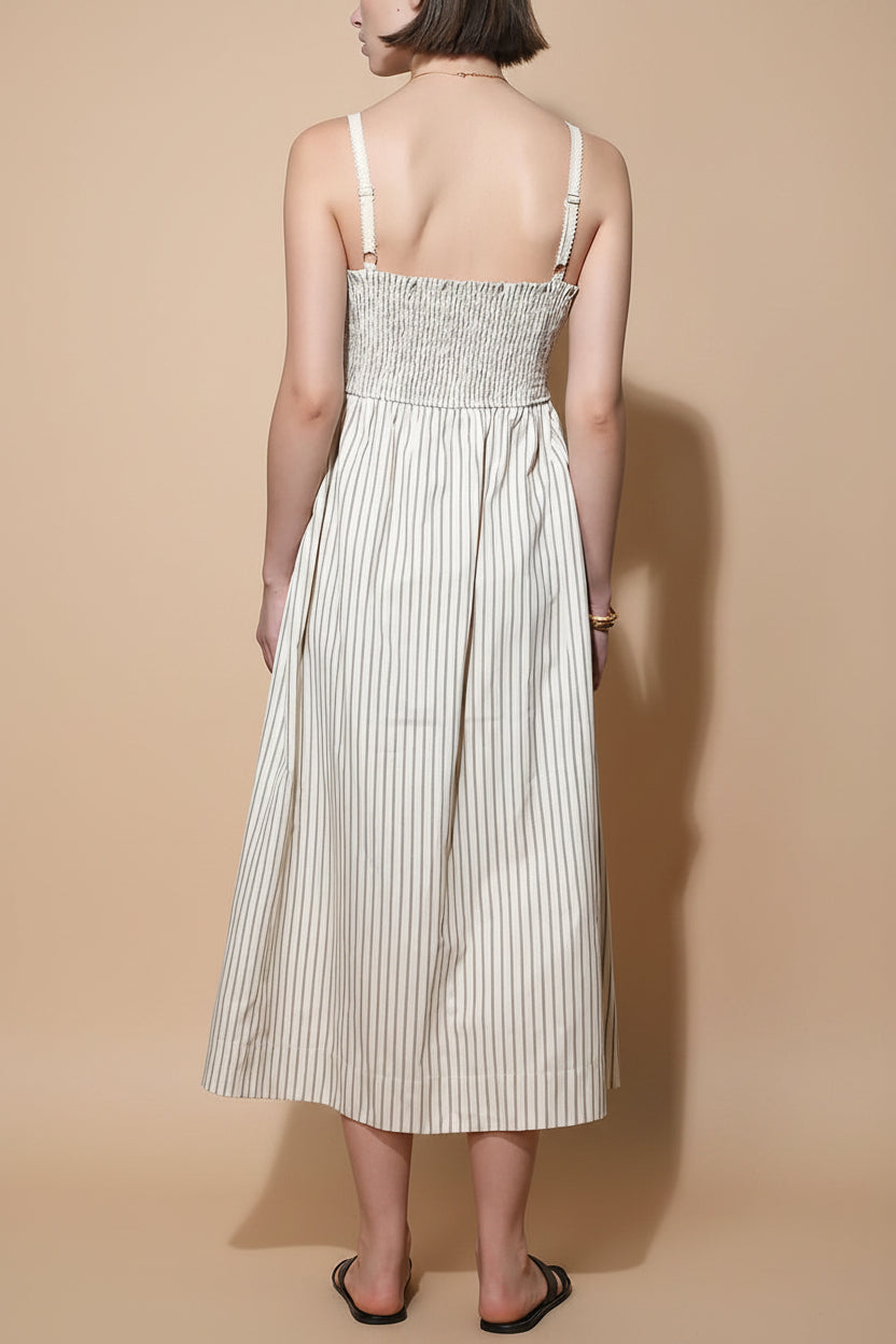 back view of a woman wearing Palashi Ivory Striped Sleeveless Midi Dress with Pockets from Boutique 1861