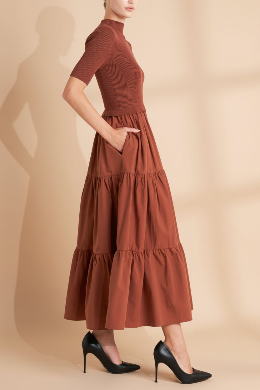Side view of a woman wearing the Penrith Rust Mock Neck Midi Dress from boutique 1861