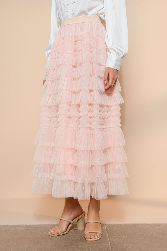 side view of a woman wearing Poema Blush Tiered Tulle Maxi Skirt from Boutique 1861