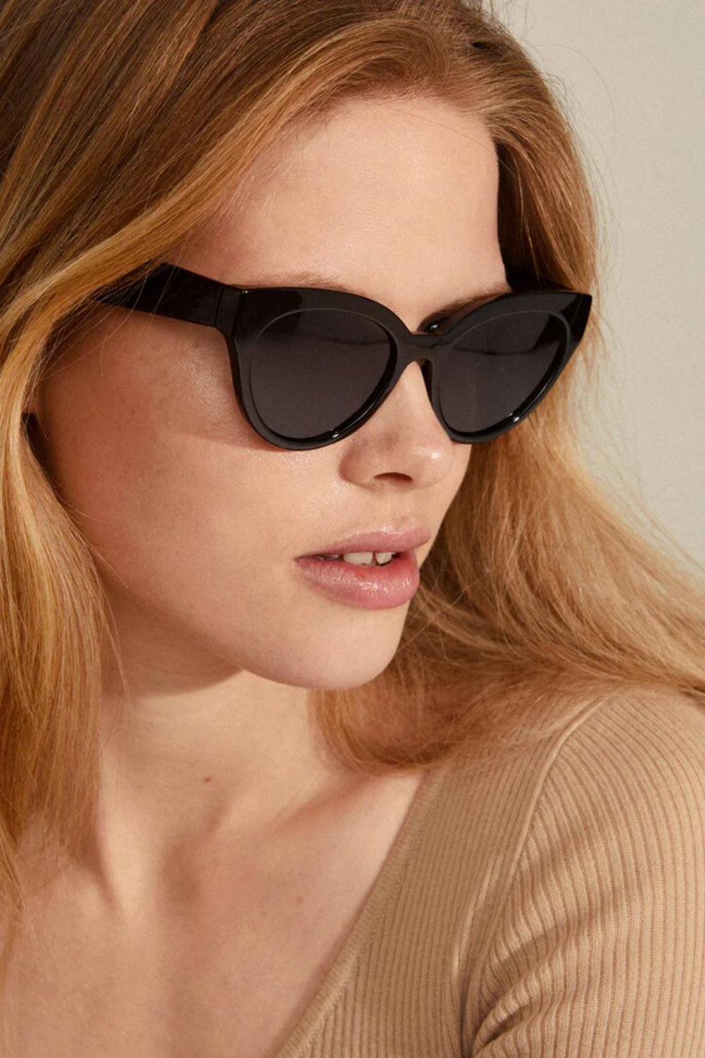 Woman wearing black cat-eye sunglasses Raisa from Pilgrim available at la petite garçonne