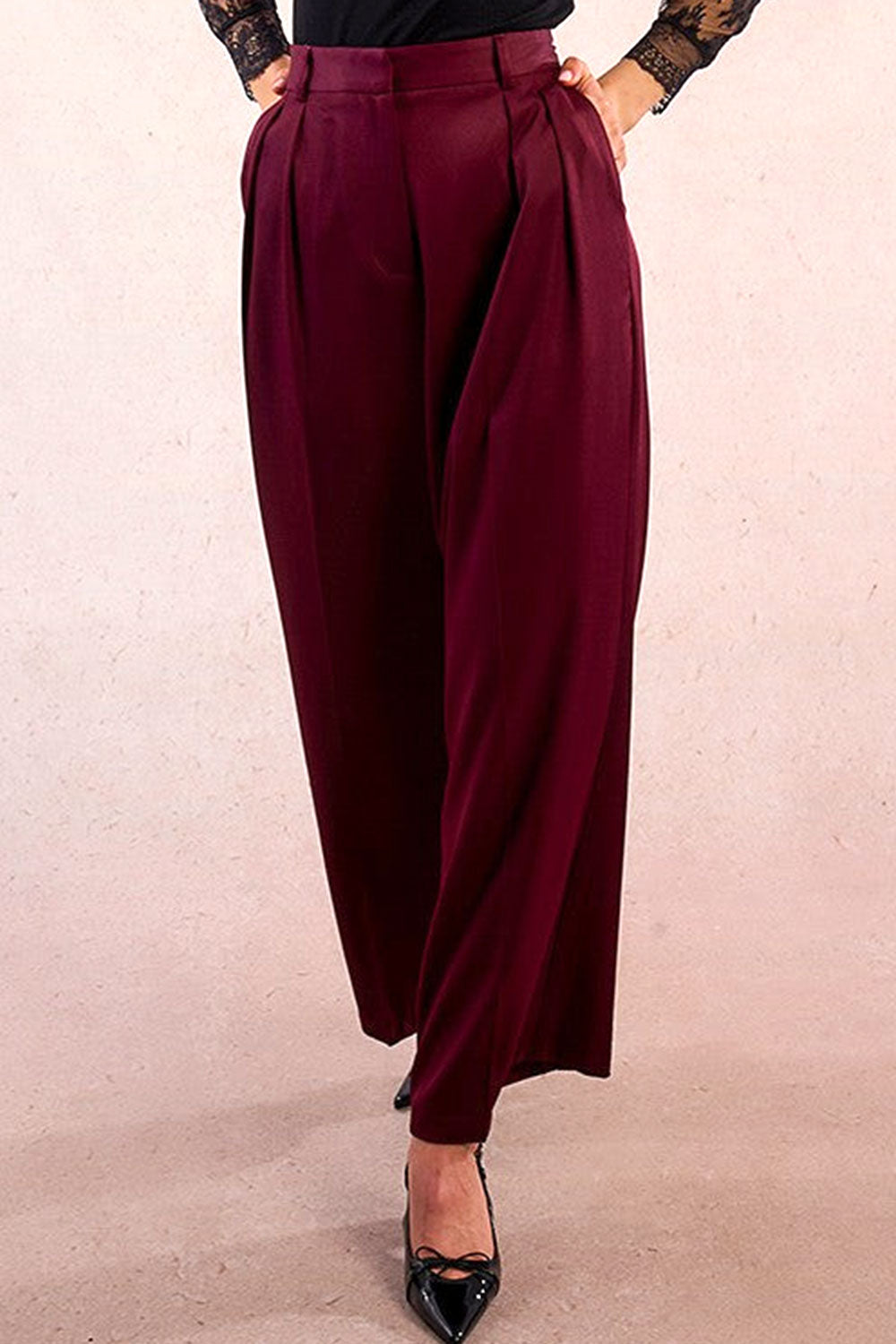 person wearing Rialto High-Waisted Pleated Burgundy Pants from La petite garçonne front