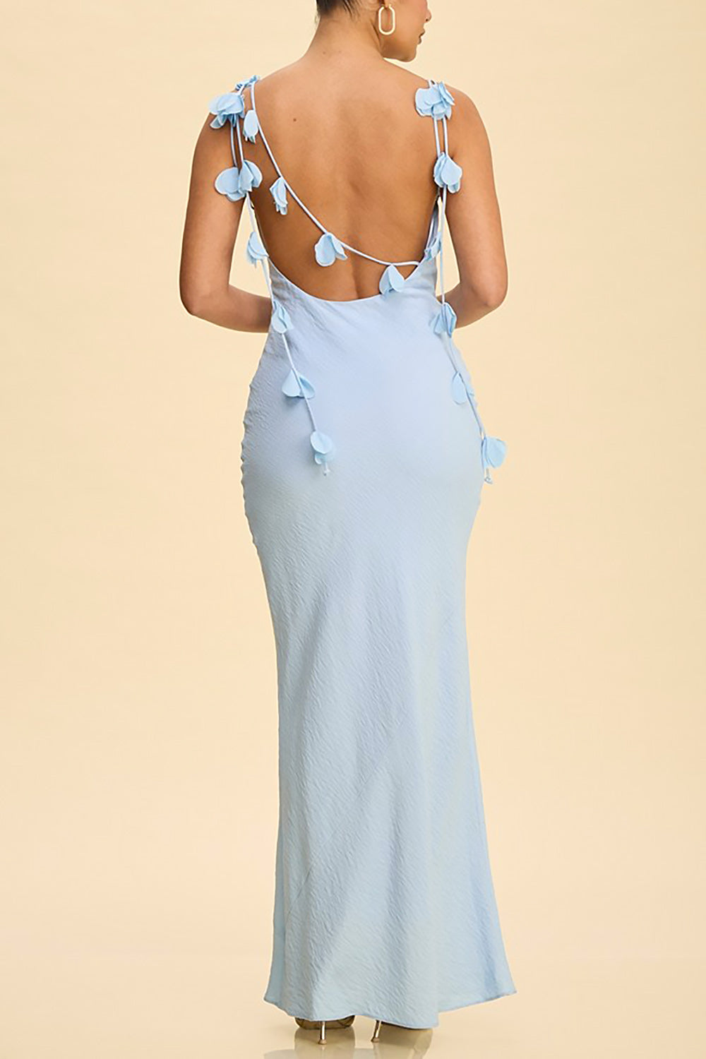 back of a woman wearing Saemi Light Blue Maxi Open Back Gown with Flower Embellishments from Boutique 1861 