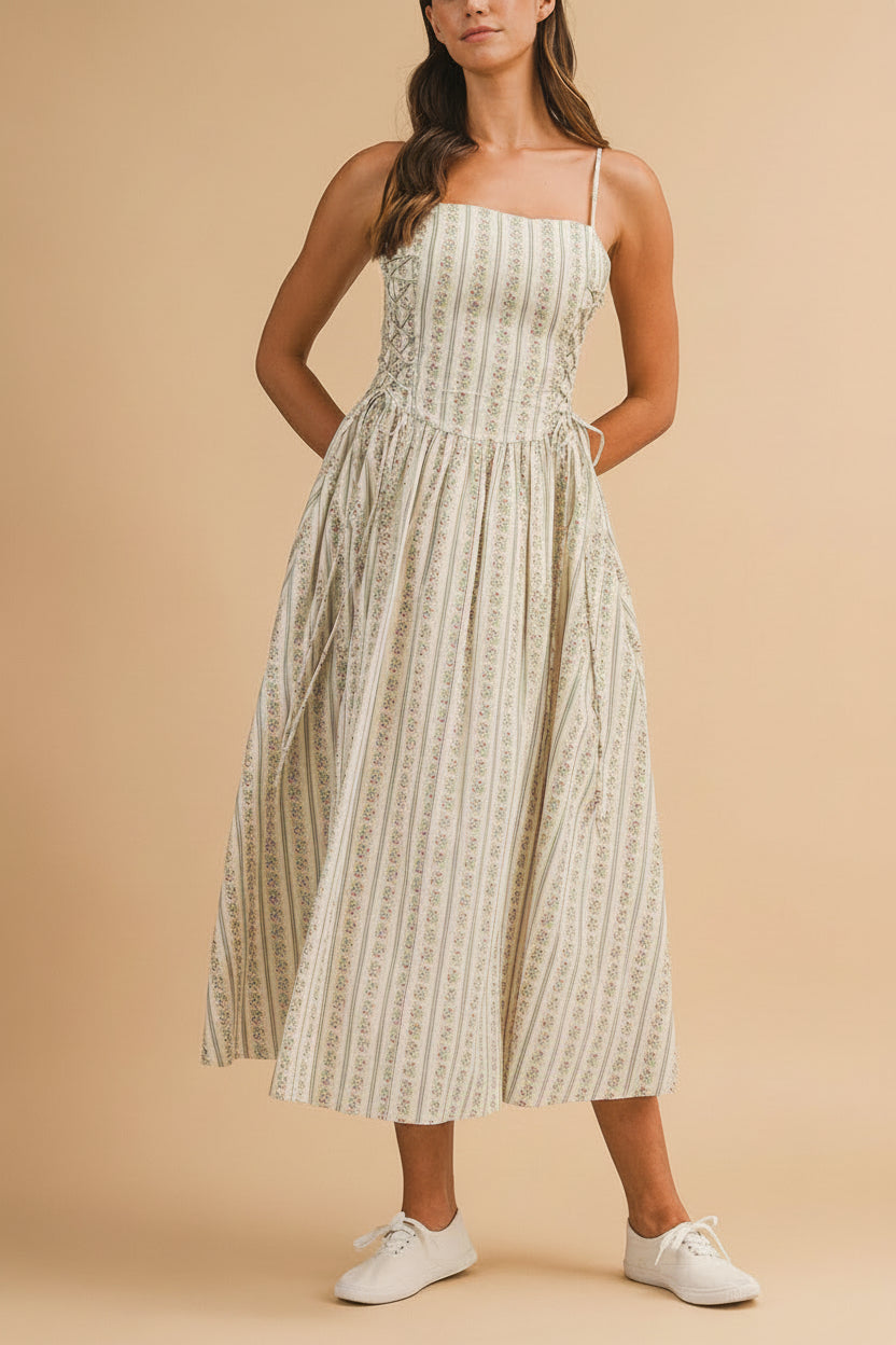 view of a woman wearing Saratou Floral Stripe Maxi Dress with Side Lace-Up Detail from Boutique 1861