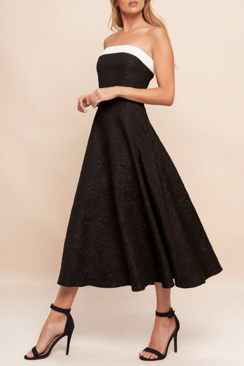 Side view of a woman wearing Solana Black Dress with Floral Waffled Texture from boutique 1861