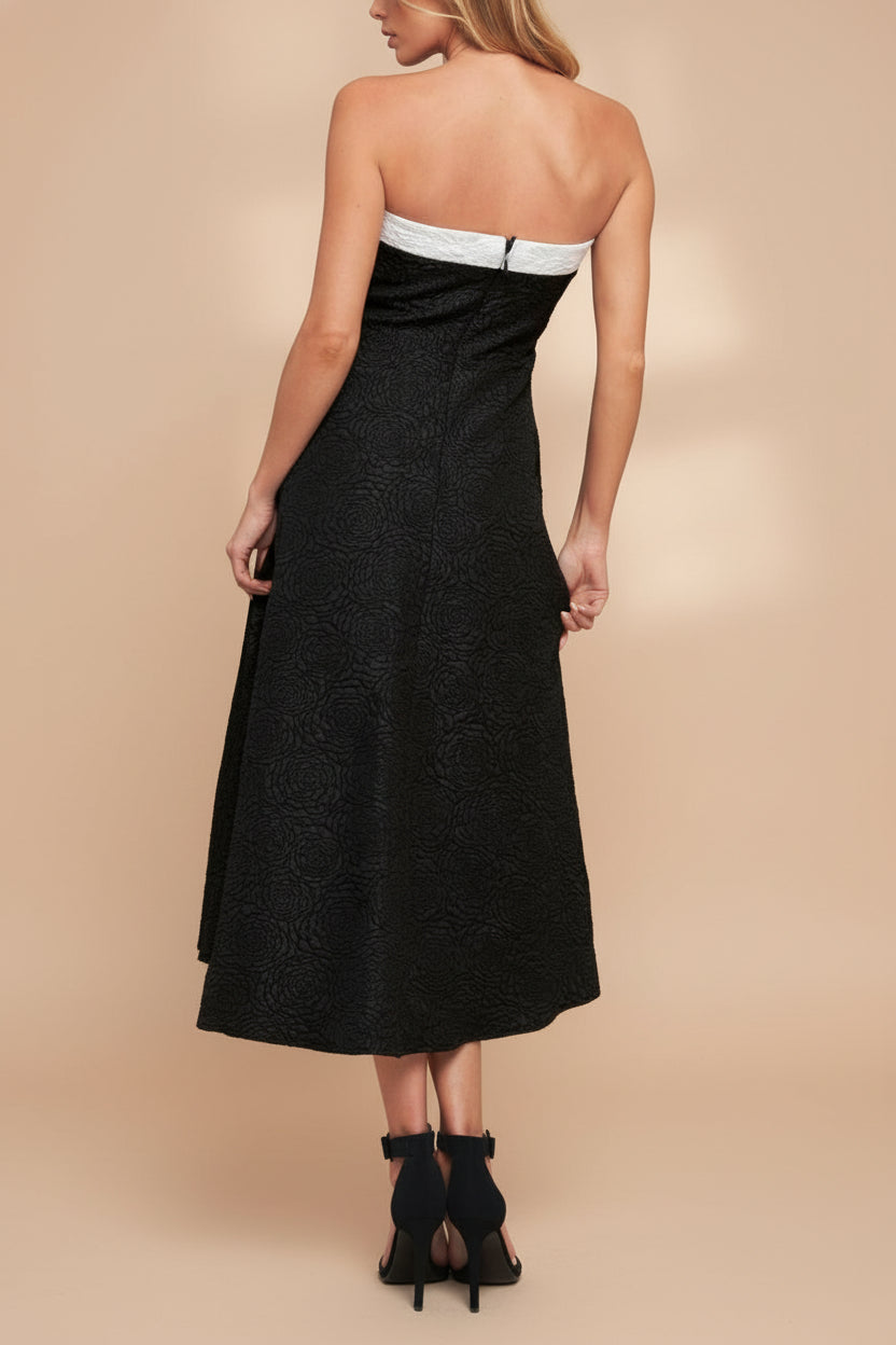 Back view of a woman wearing Solana Black Dress with Floral Waffled Texture from boutique 1861