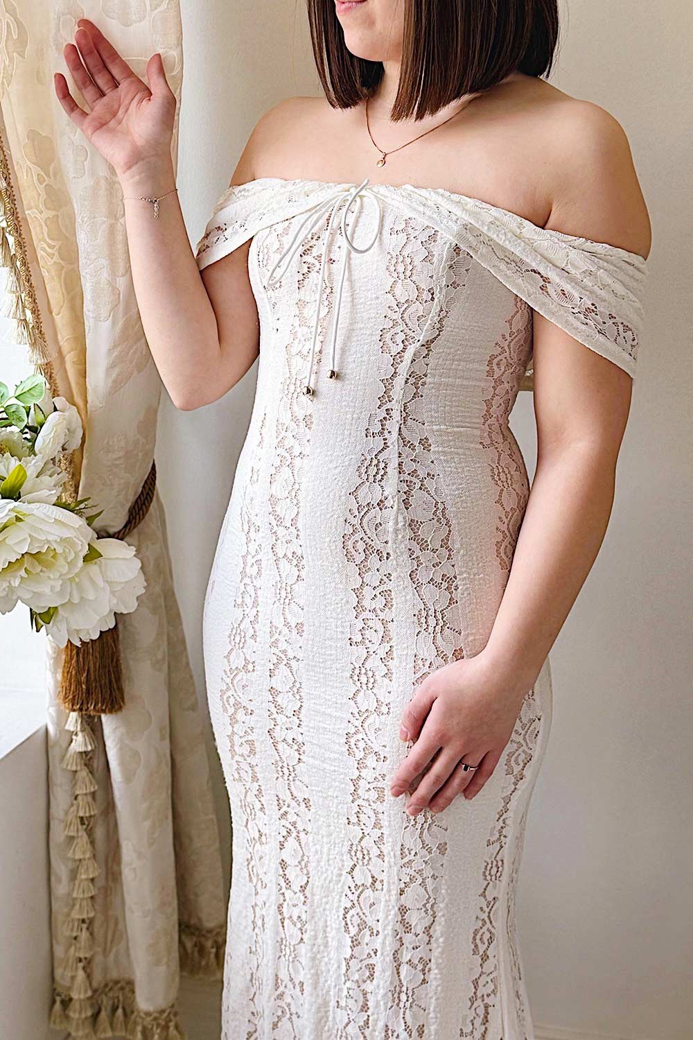 close-up of a model wearing Sangaya Off-Shoulder Cream Lace Maxi Dress from Boudoir 1861