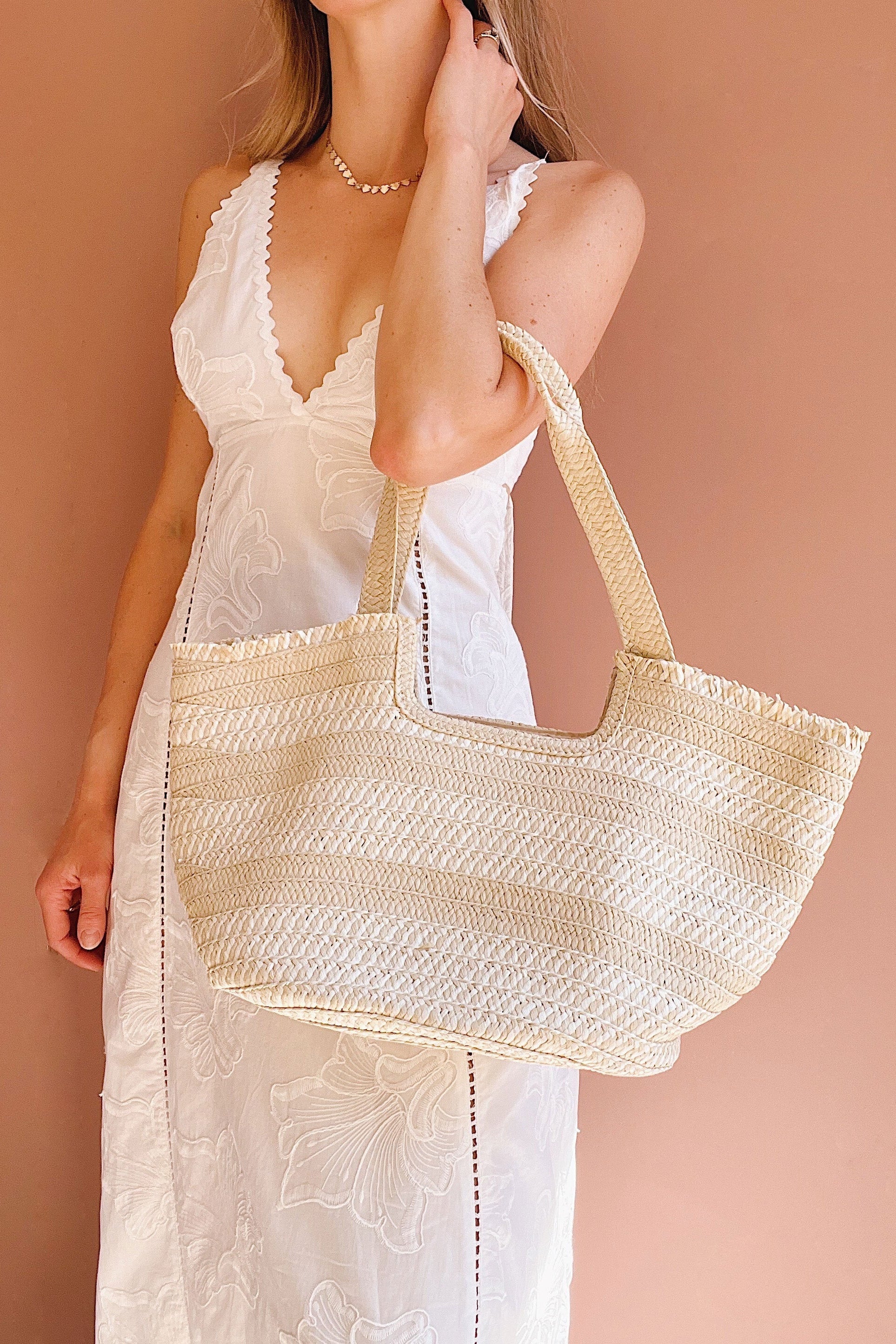 woman wearing Saturday Woven Straw Tote Bag with Braided Handles from la petite garçonne