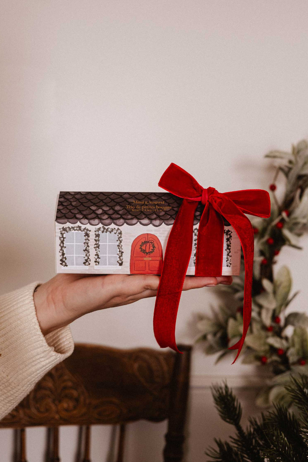 Hand holding a Little Christmas gift Box 3 set candle by mimi and august