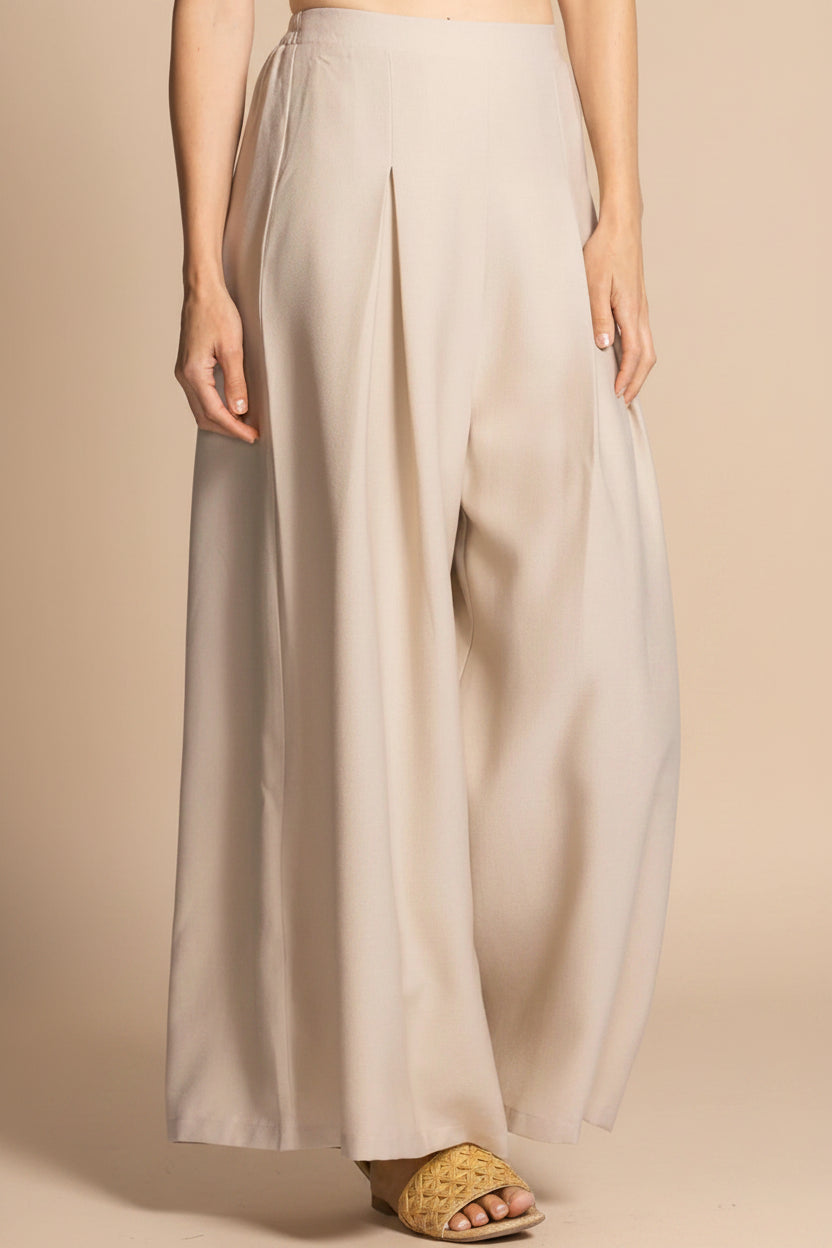 front of a woman wearing Varallo Beige Wide Leg Pants with Front Pleats from La petite garçonne