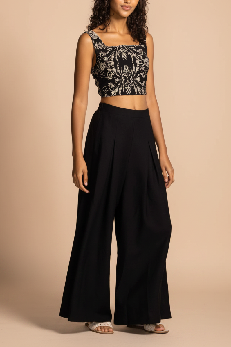 profile view of a woman wearing Varallo Black Wide Leg Pants with Front Pleats from La petite garçonne 