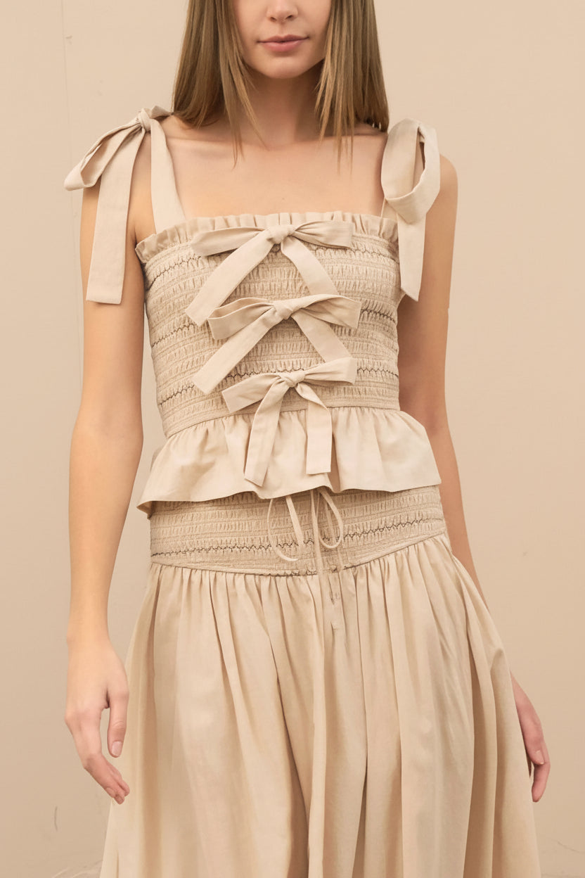 front of a woman wearing Whitney Beige Ruched Top with Bows from Boutique 1861