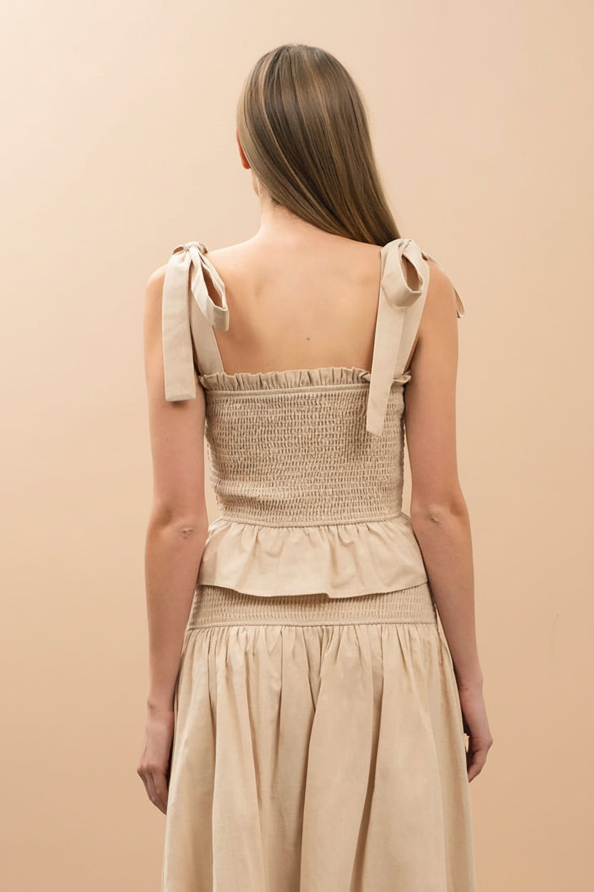 back of a woman wearing Whitney Beige Ruched Top with Bows from Boutique 1861