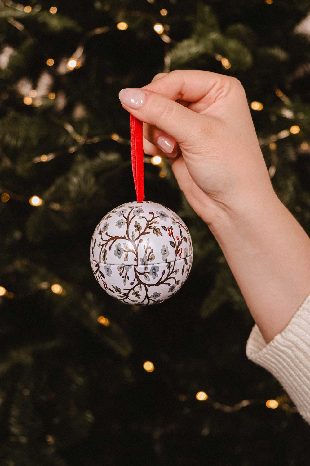 Decorative Winter Flower Christmas candle ornament with floral pattern on a wooden surface with greenery by Mimi & August