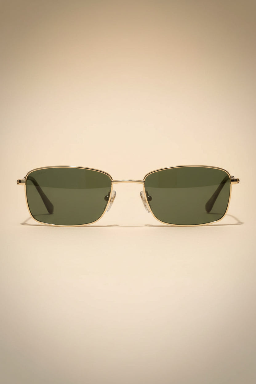 Sunglasses with gold frame and dark lenses by pilgrim on a white background