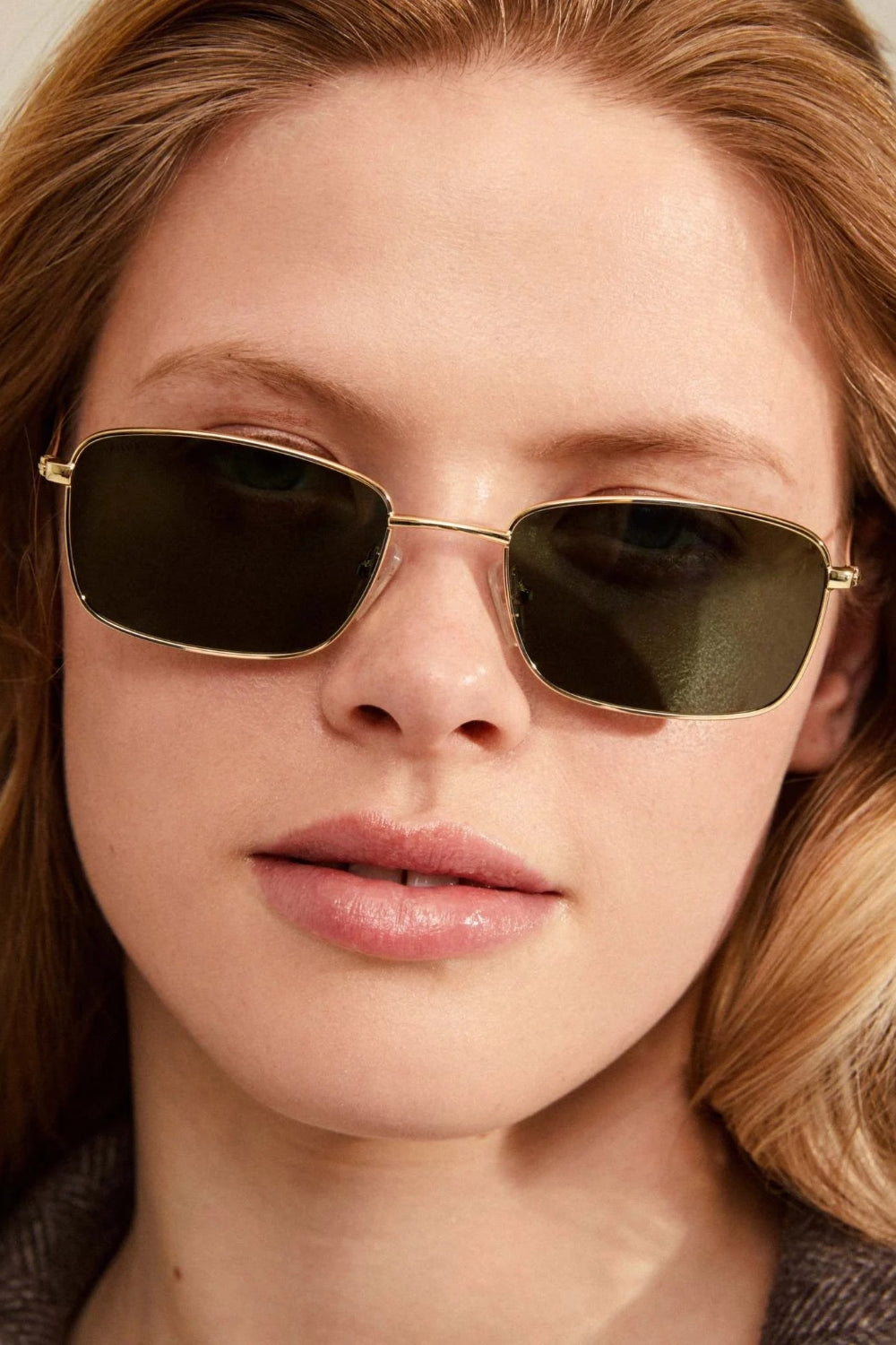 Woman wearing gold-framed sunglasses from Pilgrim available at la petite garçonne