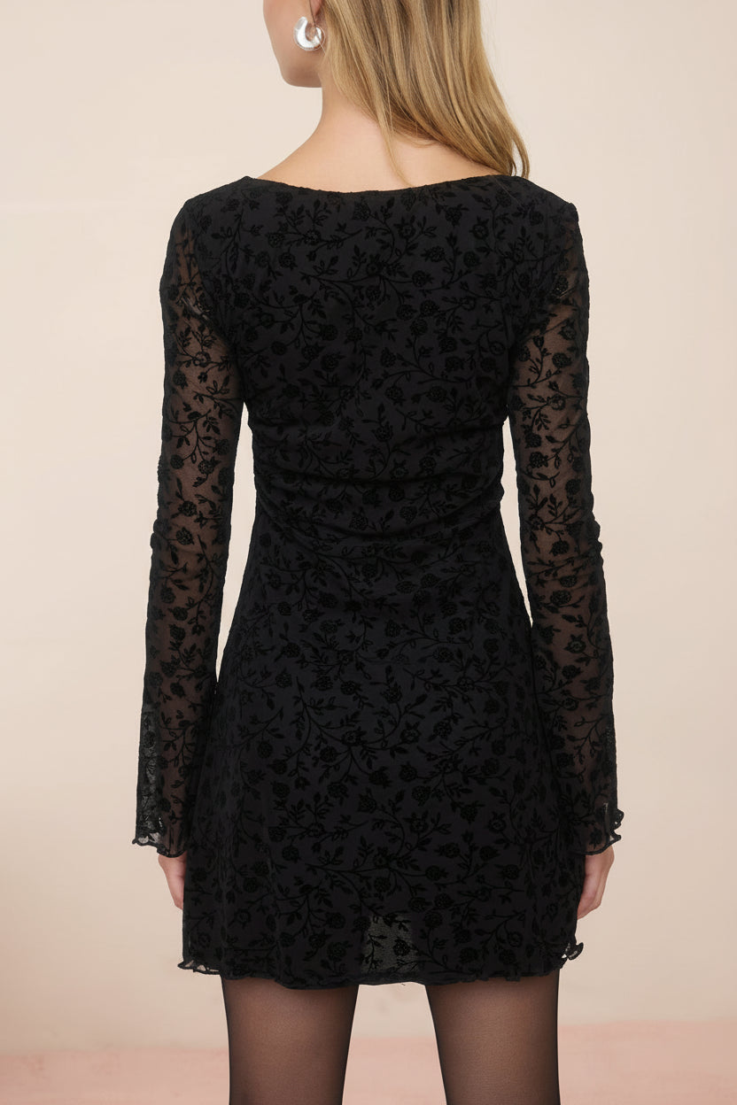 back view of a woman wearing a Zoeline Short Long-Sleeved Black Dress from boutique 1861