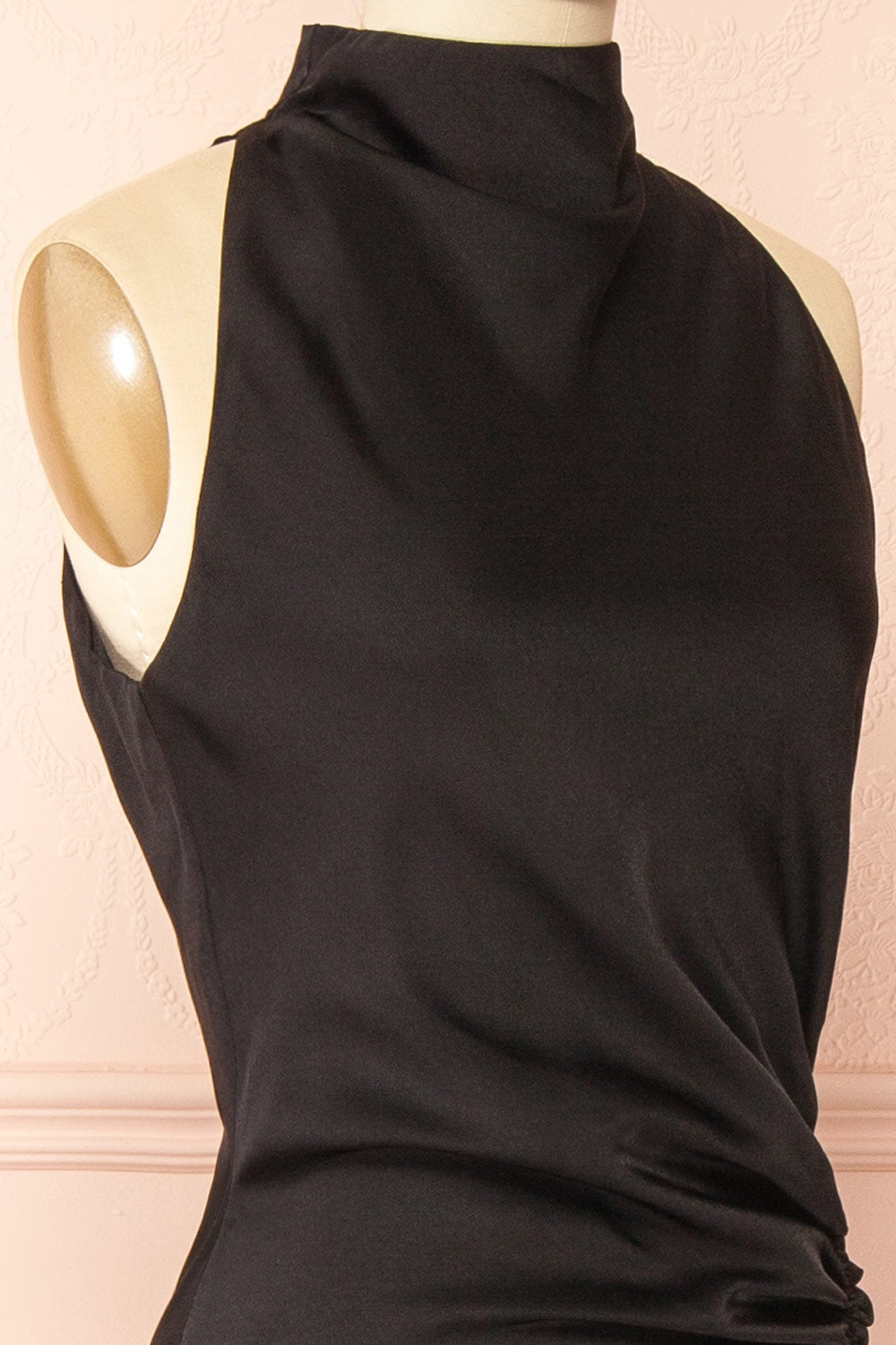side of a sewing mannequin wearing the Alberta Black Maxi Dress with a high neckline from Boutique 1861.