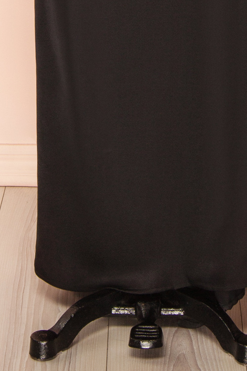 bottom of a sewing mannequin wearing the Alberta Black Maxi Dress with a high neckline from Boutique 1861.