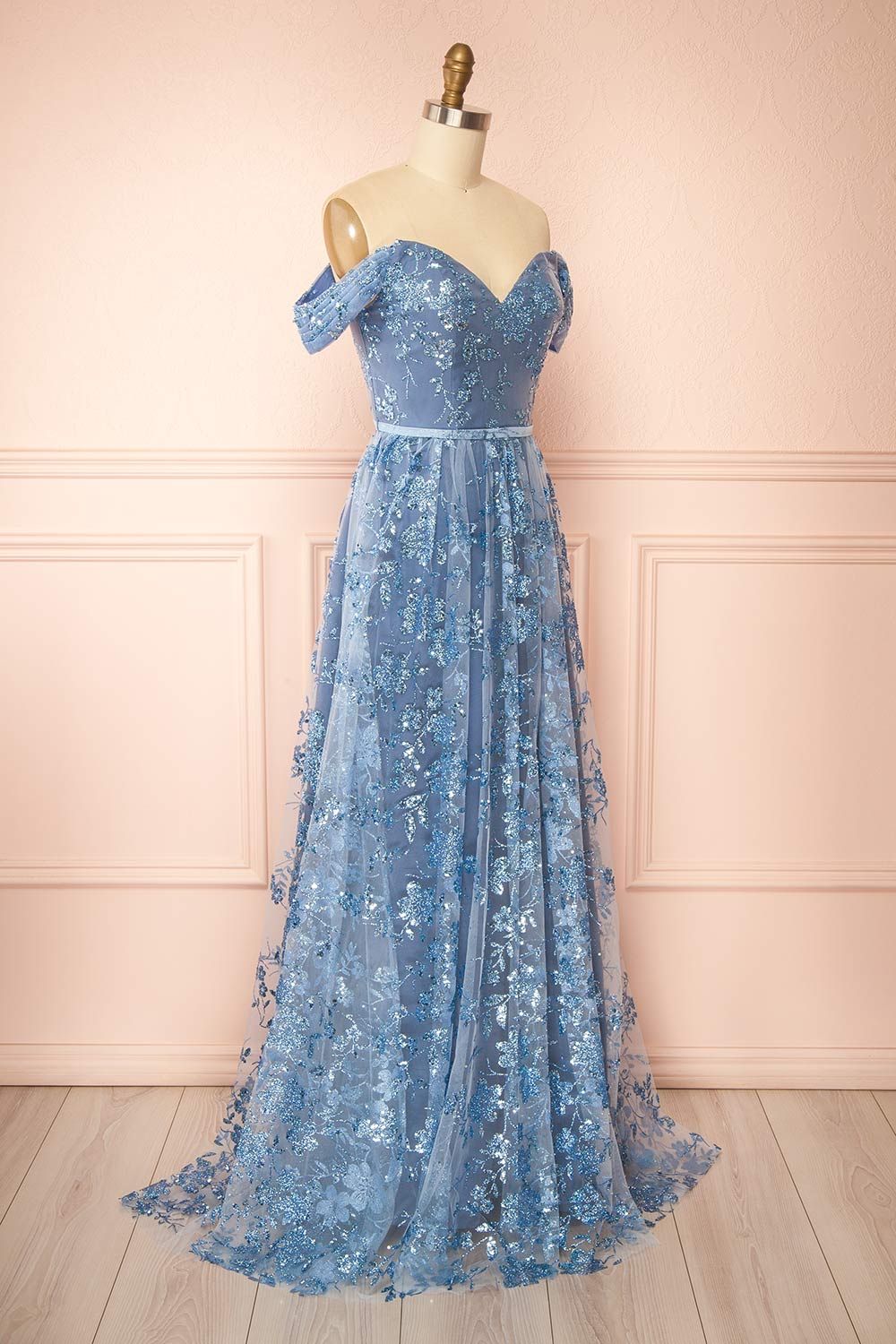 side view of sewing mannequin wearing Alienor Blue Grey Glittery Off the Shoulder Maxi Dress from Boutique 1861